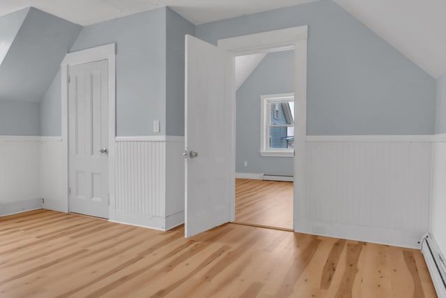120 Holland St, Lewiston, ME 04240 - bonus room with a baseboard heating unit, baseboard heating, wood finished floors, vaulted ceiling, and wainscoting
