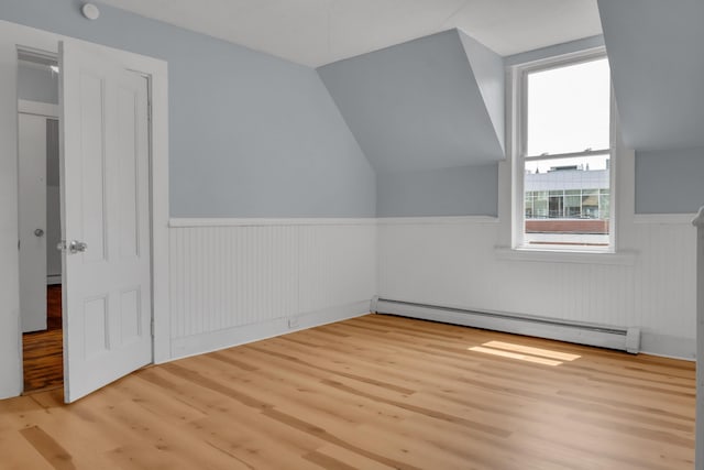 120 Holland St, Lewiston, ME 04240 - additional living space featuring a baseboard heating unit, a wainscoted wall, wood finished floors, and lofted ceiling