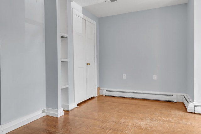 120 Holland St, Lewiston, ME 04240 - unfurnished bedroom featuring a baseboard radiator, wood finished floors, and a closet