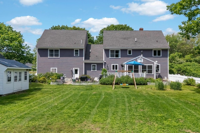 6 Ocean View Dr, Biddeford, ME 04005 - back of house with a chimney, an outbuilding, a wooden deck, a patio area, and roof with shingles