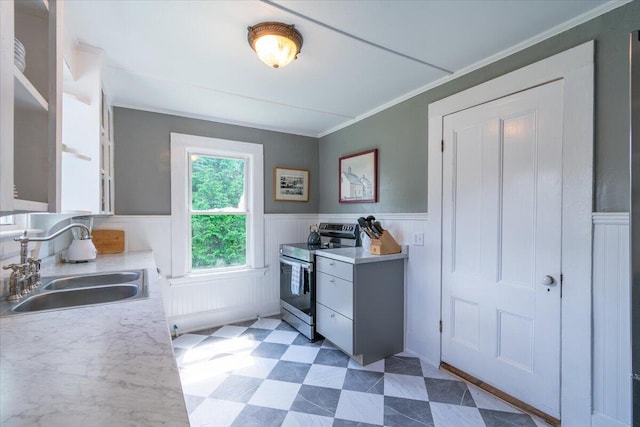 3 Salt Pond Rd, Friendship, ME 04547 - kitchen with stainless steel electric range, light countertops, wainscoting, light flooring, and crown molding