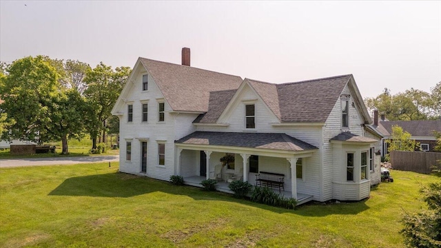 3 Salt Pond Rd, Friendship, ME 04547 - view of front of home with roof with shingles, covered porch, a front lawn, and a chimney