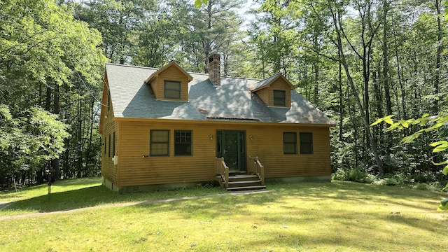 105 Highland Pines Rd, Bridgton, ME 04009 - view of front of home with a front yard, a chimney, and view of wooded area