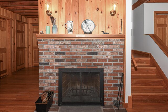 105 Highland Pines Rd, Bridgton, ME 04009 - detailed view of wood finished floors, a brick fireplace, and wood walls