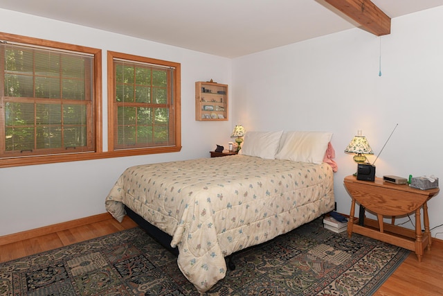 105 Highland Pines Rd, Bridgton, ME 04009 - bedroom with wood finished floors and beam ceiling