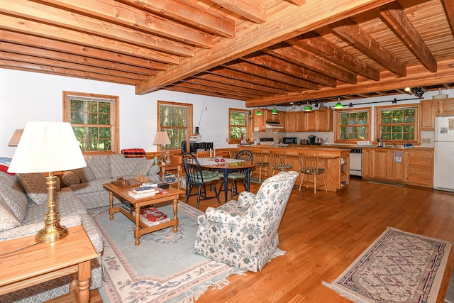 105 Highland Pines Rd, Bridgton, ME 04009 - living area with wood finished floors and a wood ceiling with exposed beams