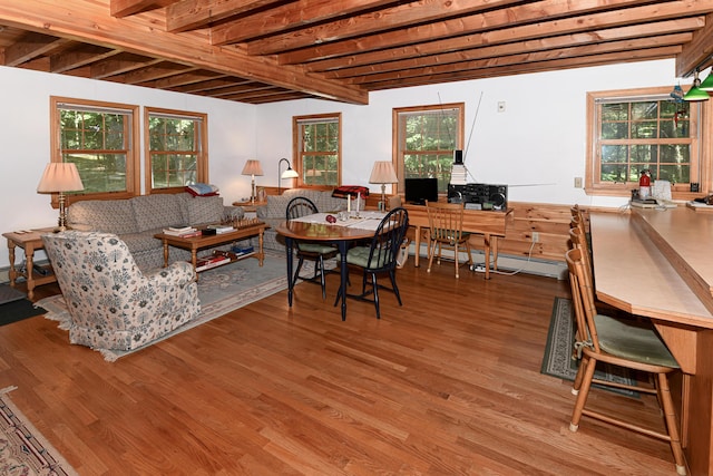 105 Highland Pines Rd, Bridgton, ME 04009 - dining area with wood finished floors, beam ceiling, and a baseboard radiator