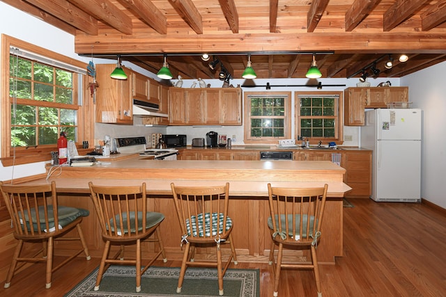 105 Highland Pines Rd, Bridgton, ME 04009 - kitchen featuring white appliances, under cabinet range hood, dark wood finished floors, and a wooden ceiling with exposed beams