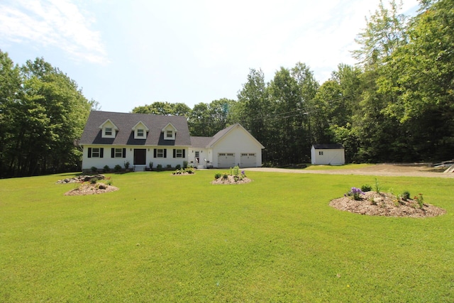 429 Moosehead Trail Highway, Waldo, ME 04915 - view of front of house with driveway, a garage, a front lawn, and a storage shed