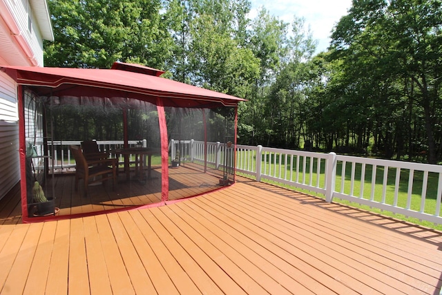 429 Moosehead Trail Highway, Waldo, ME 04915 - wooden deck with a lawn, a gazebo, and view of wooded area