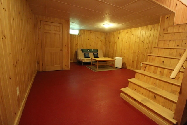 429 Moosehead Trail Highway, Waldo, ME 04915 - sitting room with stairs, a drop ceiling, wood walls, and carpet