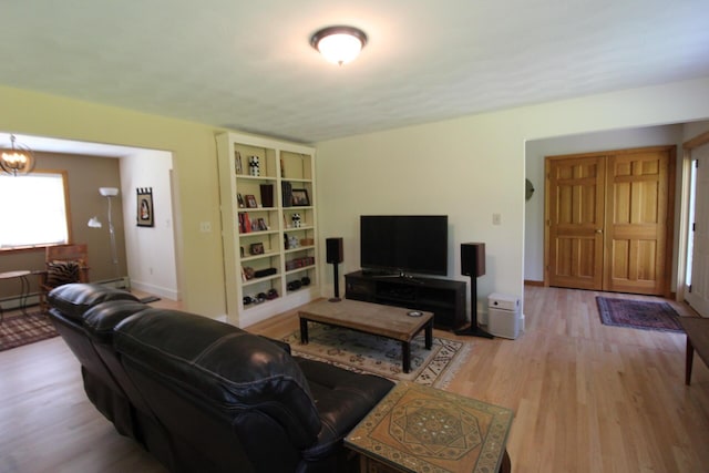 429 Moosehead Trail Highway, Waldo, ME 04915 - living room featuring wood finished floors and a chandelier