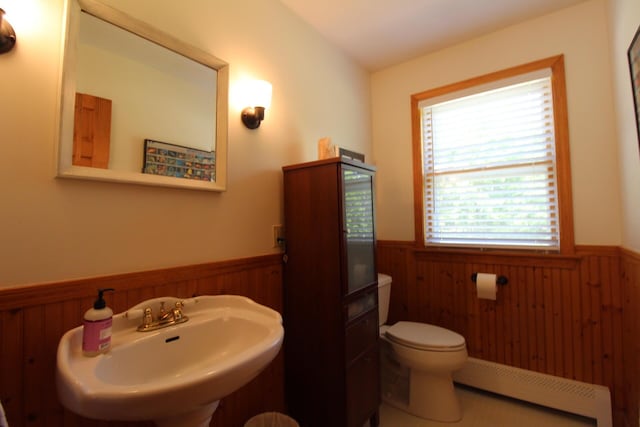 429 Moosehead Trail Highway, Waldo, ME 04915 - bathroom with a wainscoted wall, a baseboard radiator, and wooden walls