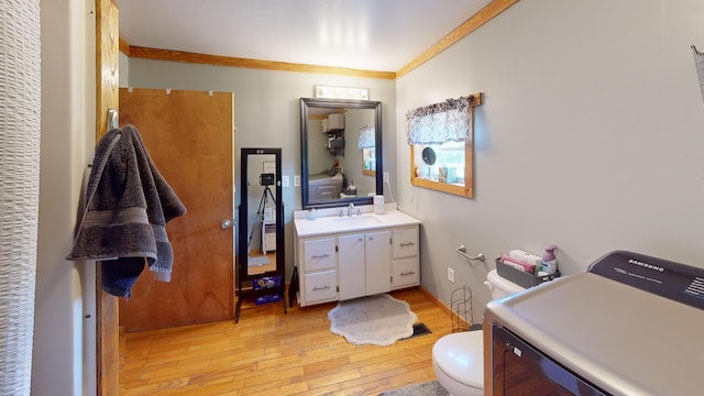 37 Mill St, Enfield, ME 04493 - bathroom featuring washer / clothes dryer, vanity, hardwood / wood-style floors, and crown molding
