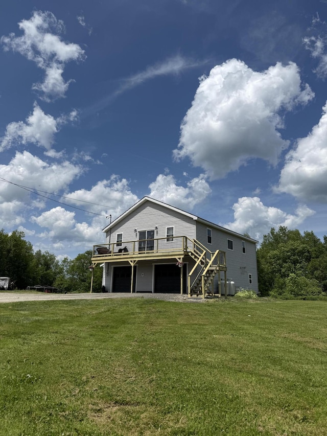 37 Mill St, Enfield, ME 04493 - back of house with a deck, stairs, a lawn, an attached garage, and driveway