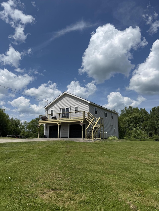 37 Mill St, Enfield, ME 04493 - rear view of house featuring a deck, stairway, a garage, and a lawn