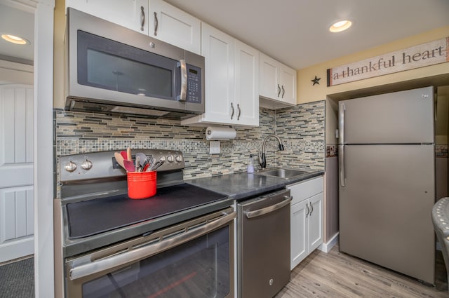 3 Pondview Dr, Lewiston, ME 04240 - kitchen with appliances with stainless steel finishes, white cabinetry, light wood finished floors, decorative backsplash, and recessed lighting