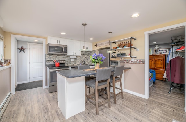 3 Pondview Dr, Lewiston, ME 04240 - kitchen featuring stainless steel appliances, baseboard heating, dark countertops, white cabinets, and light wood-style flooring