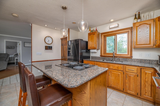 3 Pondview Dr, Lewiston, ME 04240 - kitchen with refrigerator with ice dispenser, black electric cooktop, light tile patterned floors, a breakfast bar, and recessed lighting