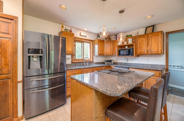 3 Pondview Dr, Lewiston, ME 04240 - kitchen with stainless steel refrigerator with ice dispenser, brown cabinets, a kitchen breakfast bar, a center island, and light tile patterned floors