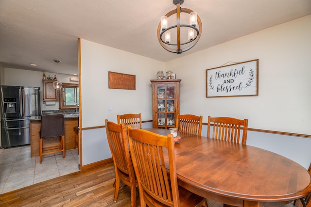 3 Pondview Dr, Lewiston, ME 04240 - dining area with a chandelier and light wood-style flooring