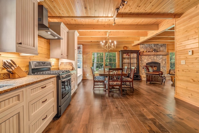 37 Parkhill Point Rd, Belgrade, ME 04917 - kitchen featuring stainless steel gas stove, wall chimney range hood, wood walls, a wood ceiling with exposed beams, and a chandelier