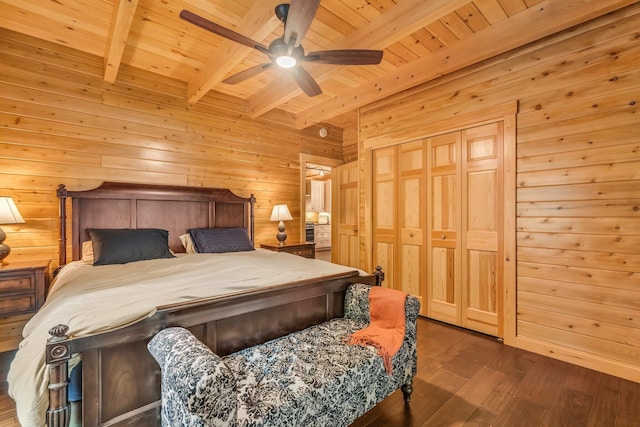 37 Parkhill Point Rd, Belgrade, ME 04917 - bedroom with a wooden ceiling with exposed beams, wooden walls, dark wood finished floors, ceiling fan, and a closet