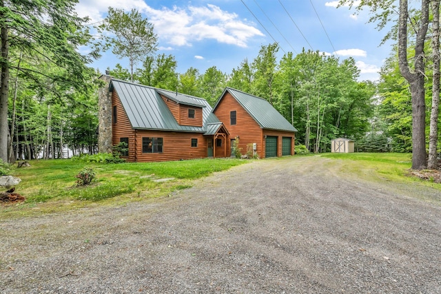 37 Parkhill Point Rd, Belgrade, ME 04917 - view of front facade with a storage shed, a garage, a metal roof, dirt driveway, and log veneer siding
