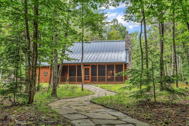 37 Parkhill Point Rd, Belgrade, ME 04917 - back of property with a sunroom, a chimney, a standing seam roof, and a metal roof
