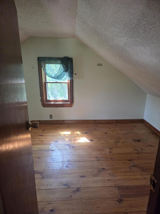 192 Old Bangor Rd, Newport, ME 04953 - bonus room with wood-type flooring, vaulted ceiling, and a textured ceiling