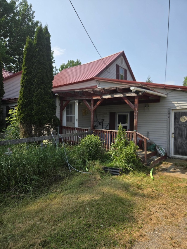 192 Old Bangor Rd, Newport, ME 04953 - view of front facade with a metal roof, a front lawn, and covered porch