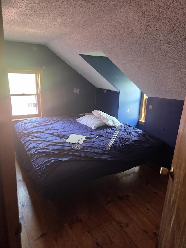 192 Old Bangor Rd, Newport, ME 04953 - bedroom with a textured ceiling, lofted ceiling, and wood-type flooring