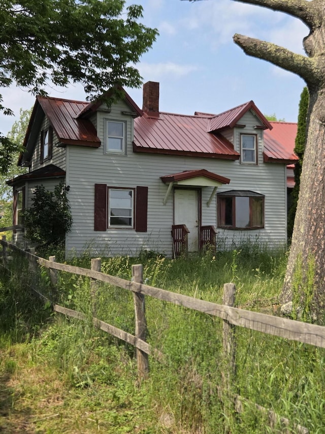 192 Old Bangor Rd, Newport, ME 04953 - view of front facade with a chimney and a metal roof