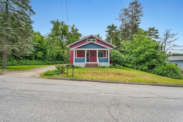 25 Foch St, Lewiston, ME 04240 - view of front of house with covered porch, driveway, and a front yard