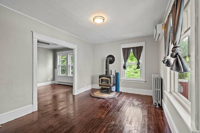 25 Foch St, Lewiston, ME 04240 - living area with radiator heating unit, a baseboard radiator, hardwood / wood-style floors, a wood stove, and ornamental molding