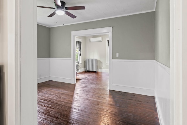 25 Foch St, Lewiston, ME 04240 - unfurnished room featuring radiator heating unit, a ceiling fan, crown molding, hardwood / wood-style flooring, and a wall unit AC