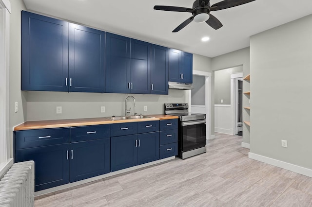25 Foch St, Lewiston, ME 04240 - kitchen with stainless steel range with electric stovetop, radiator heating unit, blue cabinetry, a ceiling fan, and under cabinet range hood
