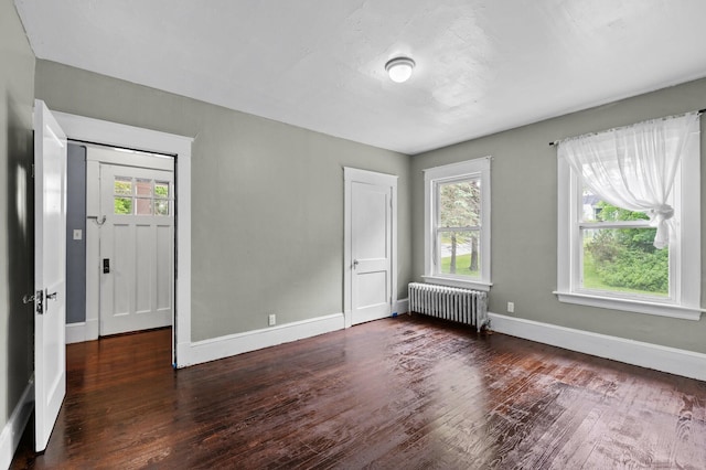 25 Foch St, Lewiston, ME 04240 - empty room featuring radiator and wood finished floors
