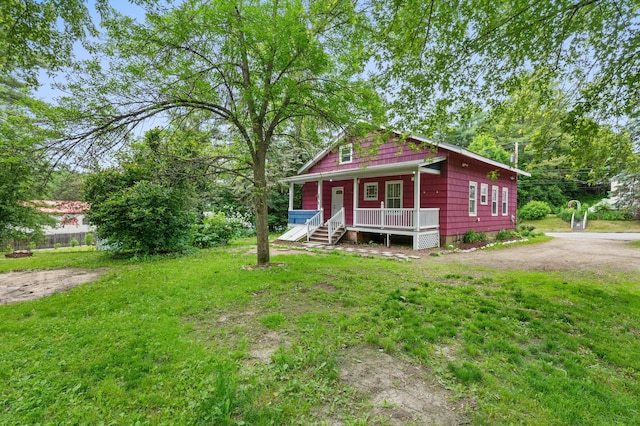 25 Foch St, Lewiston, ME 04240 - view of front of home with covered porch and a front yard