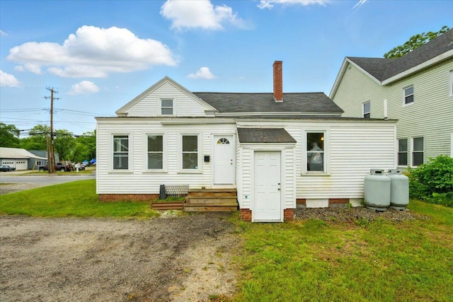 219 Lisbon St, Lisbon, ME 04250 - back of house with a shingled roof, a lawn, and a chimney