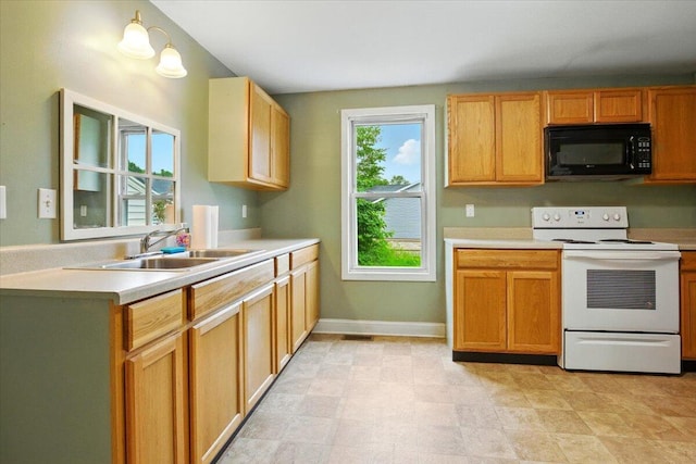 219 Lisbon St, Lisbon, ME 04250 - kitchen featuring black microwave, white electric stove, and light countertops