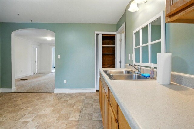 219 Lisbon St, Lisbon, ME 04250 - kitchen featuring arched walkways, light countertops, and stone finish floors