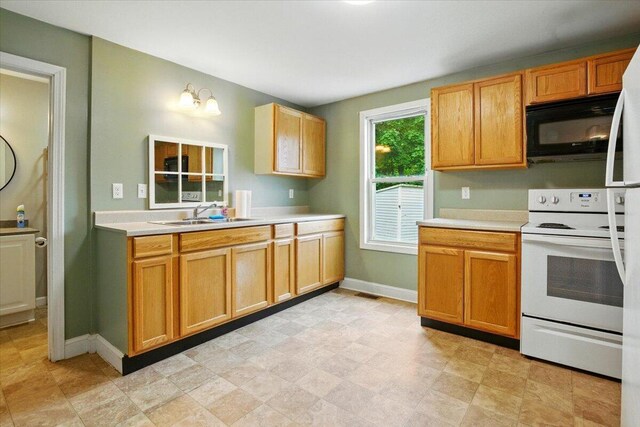 219 Lisbon St, Lisbon, ME 04250 - kitchen featuring white electric range oven, black microwave, and light countertops