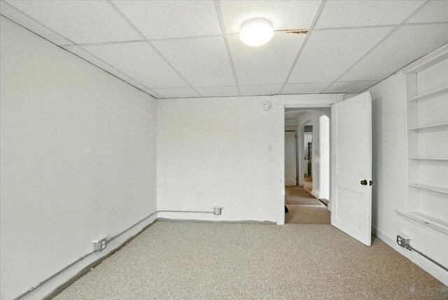 219 Lisbon St, Lisbon, ME 04250 - empty room with arched walkways, a paneled ceiling, light colored carpet, and built in features