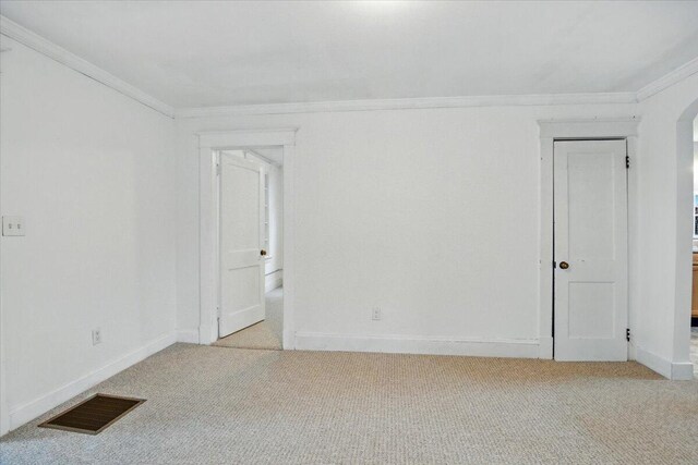 219 Lisbon St, Lisbon, ME 04250 - unfurnished room featuring ornamental molding, light colored carpet, and arched walkways