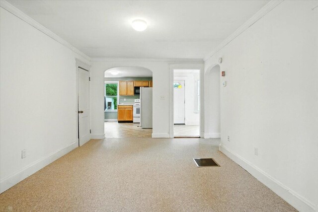 219 Lisbon St, Lisbon, ME 04250 - spare room featuring arched walkways and ornamental molding