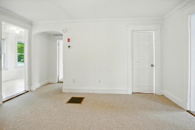 219 Lisbon St, Lisbon, ME 04250 - empty room with arched walkways, crown molding, and light carpet