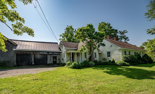 1785 Alna Rd, Alna, ME 04535 - view of front facade with a garage, dirt driveway, a front yard, and a chimney
