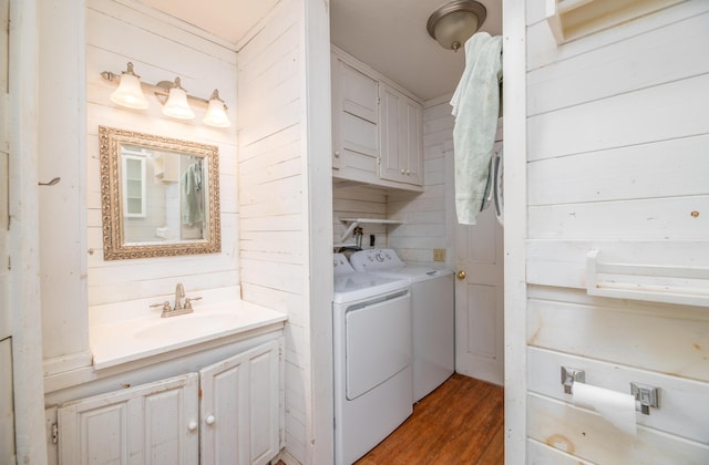 1785 Alna Rd, Alna, ME 04535 - washroom featuring washing machine and dryer, wood finished floors, and cabinet space