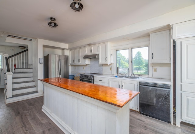 1785 Alna Rd, Alna, ME 04535 - kitchen featuring black dishwasher, freestanding refrigerator, butcher block counters, under cabinet range hood, and wood finished floors